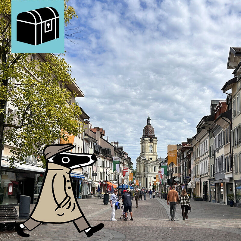 Erlebe die Detektiv-Trails mit Detektiv Dachs: Ein spannendes Rätselerlebnis für Jung und Alt. Du begibst dich auf eine Entdeckungstour durch Morges, die charmante Stadt am Ufer des Genfersees. Der Trail führt dich durch den idyllischen Parc de l’Indépendance, wo jedes Jahr das farbenfrohe Tulpenfest stattfindet, und weiter durch die malerische Altstadt mit ihren alten Gasthäusern wie der Pinte und den kunstvoll verzierten Wirtshausschildern. Beim Rathaus erfährst du, dass hier einst Audrey Hepburn geheiratet hat, und im Quartier des Halles tauchst du in das lebendige Herz der Stadt ein. Unterwegs lernst du, wer Dr. Yersin war – eine bedeutende Persönlichkeit aus der Geschichte von Morges. Der Weg führt dich zudem zum Temple de Morges, bevor du am Quai entlang zum Hafen gelangst, wo dich ein herrlicher Blick auf den See und die Alpen erwartet. Die abwechslungsreiche Route verbindet Geschichte, Rätselspass und Genuss auf unterhaltsame Weise und lässt dich Morges von seiner schönsten Seite erleben. Der Detektiv-Trail Morges bietet eine harmonische Mischung aus Rätsellösen, Bewegung und Kulturgenuss. Perfekt für Familien, Kinder, Schulklassen, Grosseltern und alle, die gerne draussen unterwegs sind. Viel Vergnügen auf deinem Rätselabenteuer!
